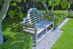 A Lutyens bench is one of the focal points in this country garden design.
