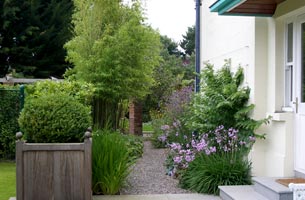 Container planting softens the formal garden design.